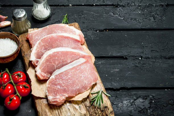 istock Raw pork steaks with spices. 1141535228