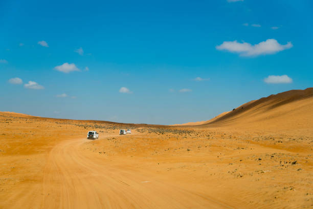 istock View of cars on desert, Oman 1141536310