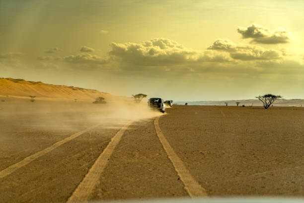 a car on a desert road in the Landscape and nature in the white desert near the village of Farafra in the lybian or western desert of Egypt in north africa