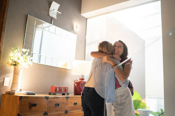 Grandmother and granddaughter embracing Hugging hello stock pictures, royalty-free photos & images