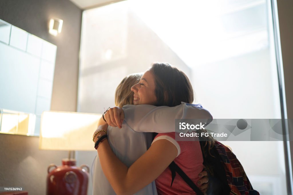 Grandmother and granddaughter embracing Hugging Embracing Stock Photo