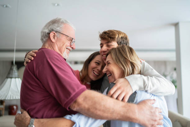 Grandchild and grandparents embracing Grandchild and grandparents embracing reunion stock pictures, royalty-free photos & images