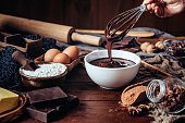 Making chocolate mousse on a wooden table in a rustic kitchen
