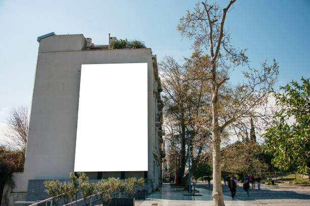 blank billboard on building facade - afixar cartaz imagens e fotografias de stock
