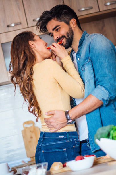istock Happy couple showing affection in the kitchen. 1141537861