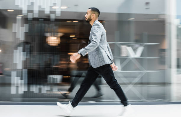 istock Businessman walking across the lobby, blurred motion 1141537900