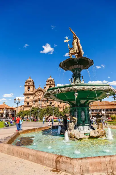Fountain of Incan emperor Pachacuti and church of the Society of Jesus at Plaza De Armas, Cuzco, Peru