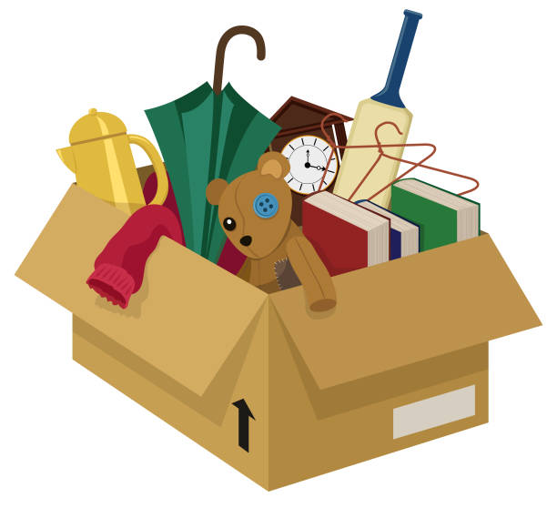 Junk Box A cardboard box filled with various household junk items belongings stock illustrations