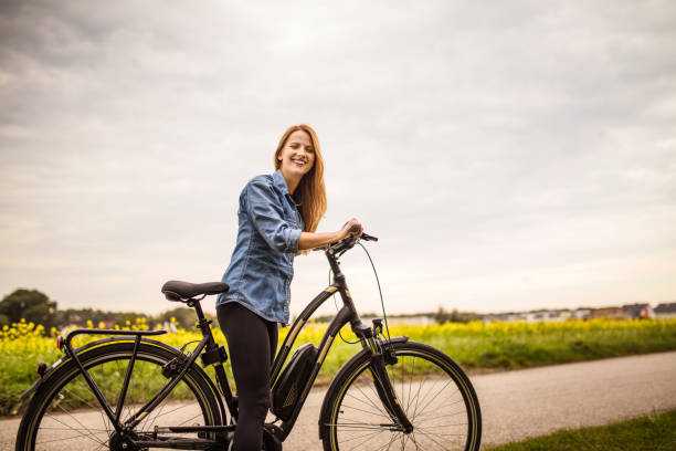 istock Woman riding on her electric bicycle 1141543511