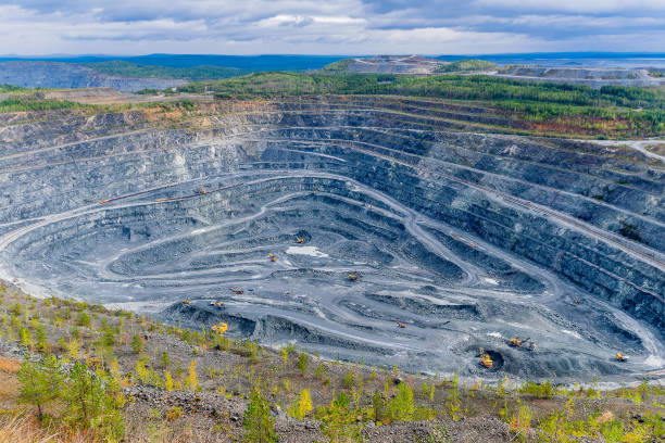istock Of opencast mining quarry, open pit mining with many machines at work, this area has been mined for copper, silver, gold, vanadium and other minerals in Russia 1141544715