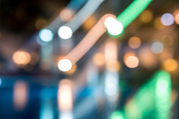 istock blurred night background, colored lights, water and buildings in defocus 1141545048