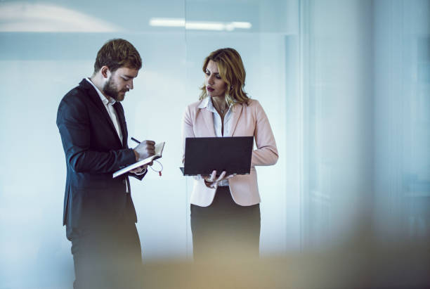 istock Two Business People Discussing in The Hallway 1141545669