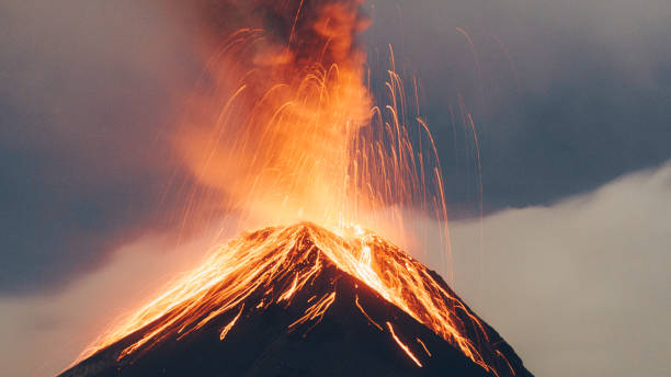 Hot orange lava coming out of fuego volcano Long exposure of the exploding crater of the volcano on the sunset erupting photos stock pictures, royalty-free photos & images