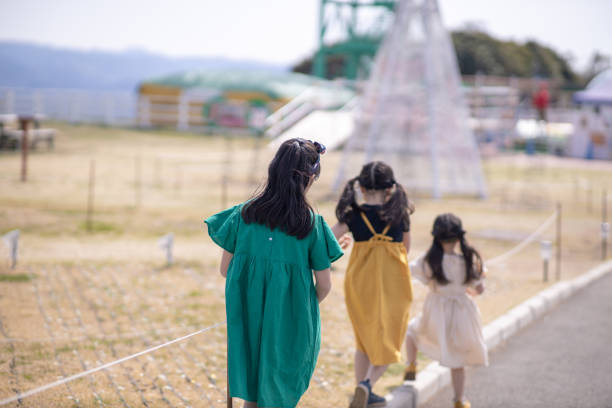 istock Three little sisters marching in public park 1141550612