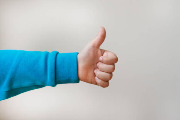 Child hand shows the number One,