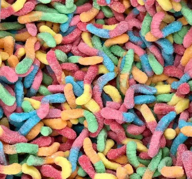 Close view of large pile of colorful sugar covered edible gummy worms