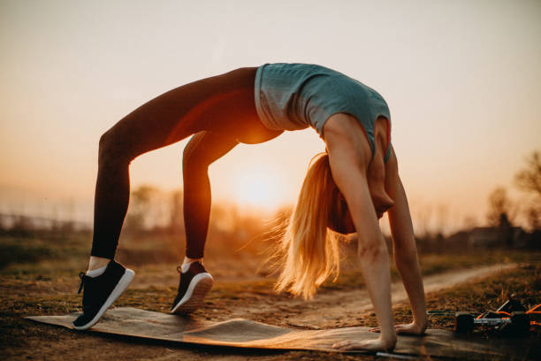 istock Woman doing exercises in meadow 1141552349
