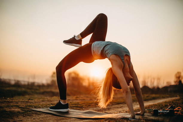 istock Woman doing exercises in meadow 1141553108