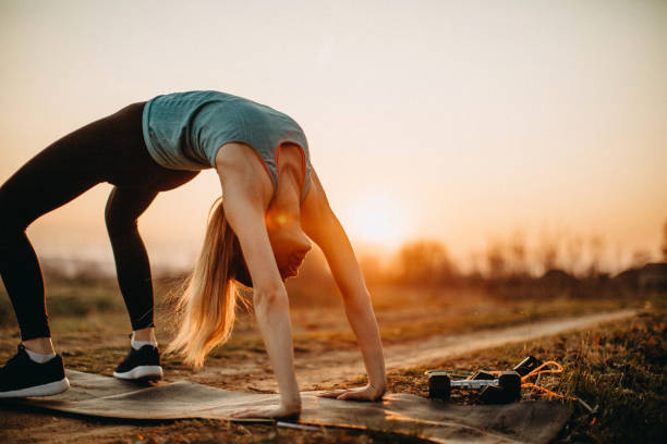 istock Woman doing exercises in meadow 1141553157