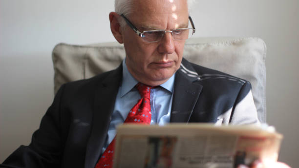 istock Senior business man reading newspaper 1141553179