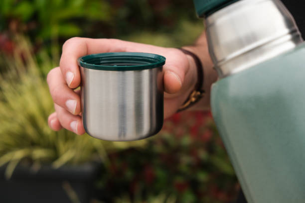 istock Traveler drinknig hot tea from thermos 1141553195