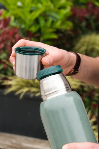 istock Traveler drinknig hot tea from thermos 1141553276