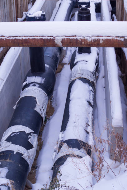 istock industrial pipelines covered in snow. construction. 1141555431