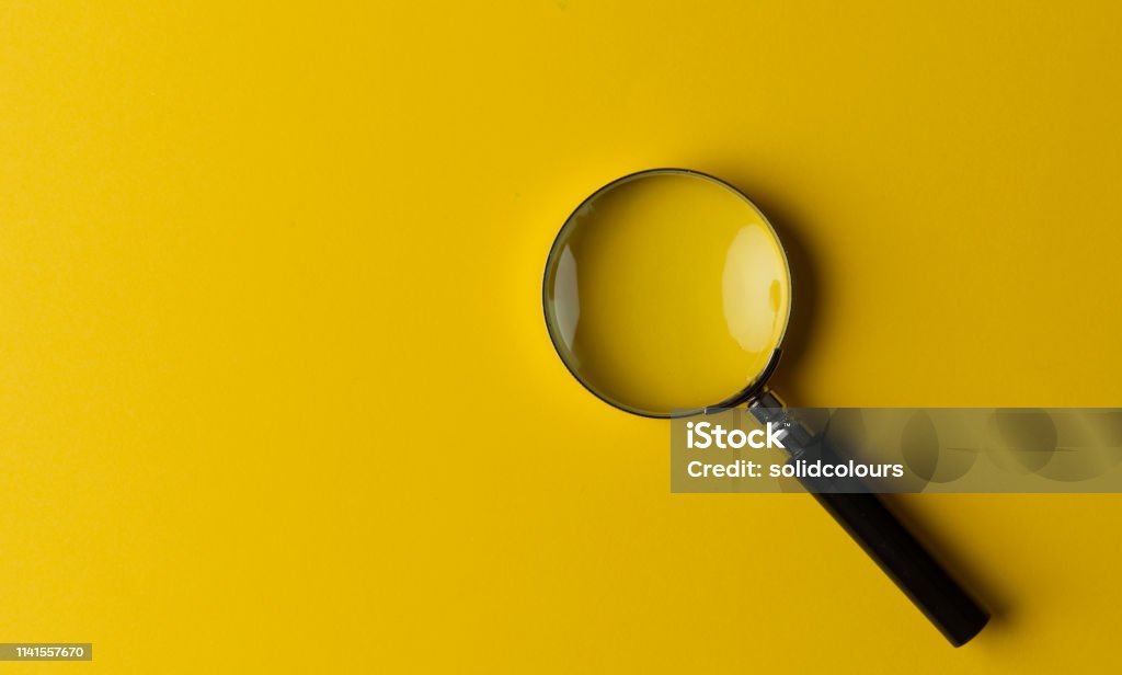 Magnifying Glass Stock Photo - Download Image Now - Magnifying Glass,  Yellow, Close-up - iStock