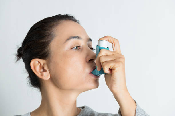 istock Woman using asthma inhaler 1141560723