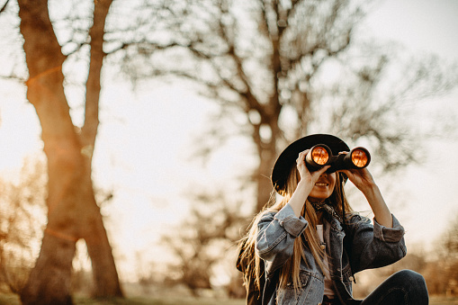 Young woman explorer walking in forest