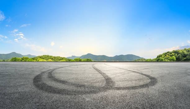 istock Empty asphalt race track and mountains with beautiful clouds at sunset 1141560921