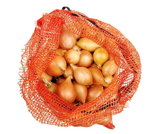 zwiebeln in netzgewebe tasche - onion bag netting vegetable stock-fotos und bilder