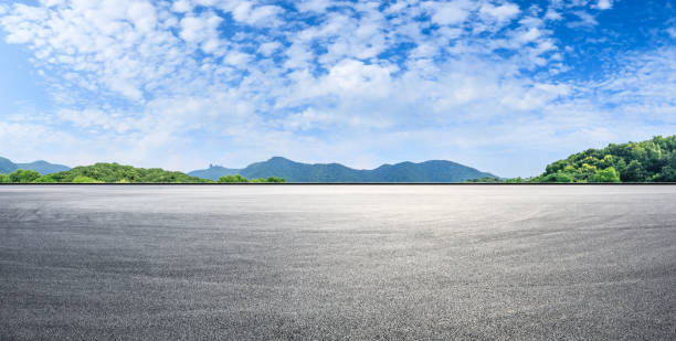 istock Empty asphalt race track and mountains with blue sky landscape 1141562262