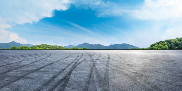istock Empty asphalt race track and mountains with blue sky landscape 1141562264