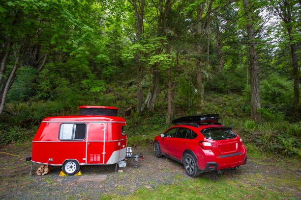 Red car and trailer Red car and retro trailer, Vancouver Island, BC, Canada - May 10, 2018: Car camping with antique tiny trailer. camper trailer photos stock pictures, royalty-free photos & images