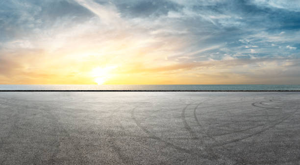 istock Asphalt race track and river with beautiful clouds at sunset 1141563134