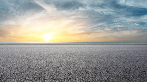 istock Asphalt road and sea with beautiful clouds at sunset 1141563228