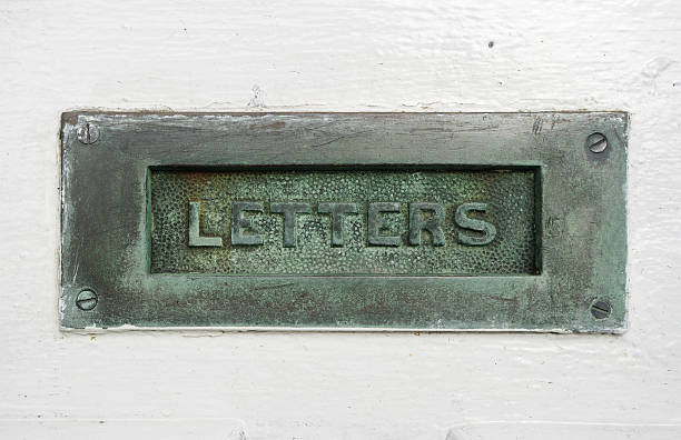 istock Old Brass Or Bronze Letterbox In White Door 114156338