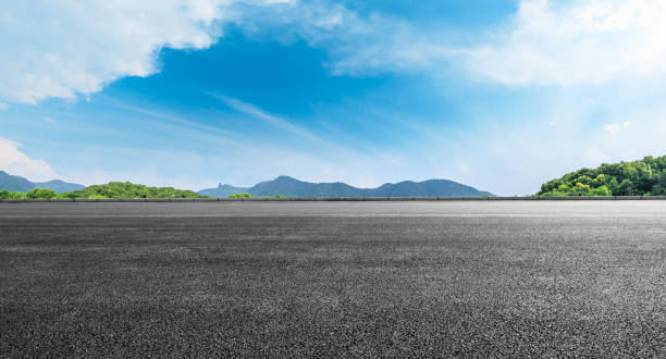 istock Asphalt road ground and mountains with blue sky on a sunny day 1141563499