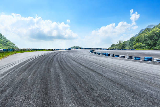 istock Asphalt race track and mountains with blue sky landscape 1141563504