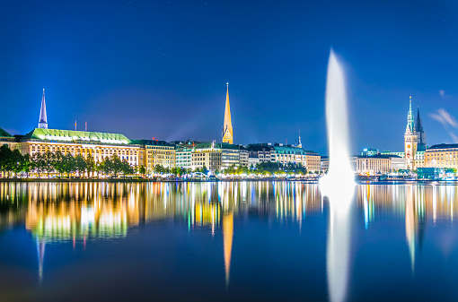 Night view of the old town in Hamburg behind binnenalster lake, Germany