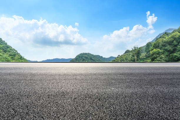 istock Asphalt road ground and mountains with blue sky on a sunny day 1141564584