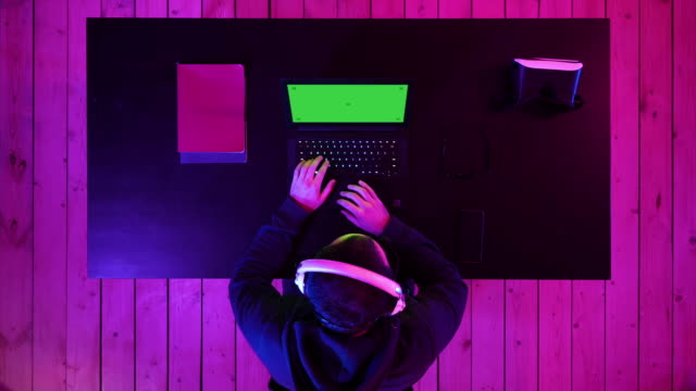 Male gamer plays games on his laptop. Green Screen Mock-up Display