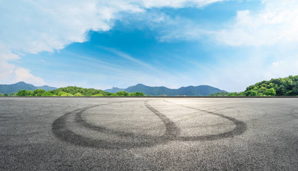 istock Empty asphalt race track and mountains with blue sky landscape 1141564688