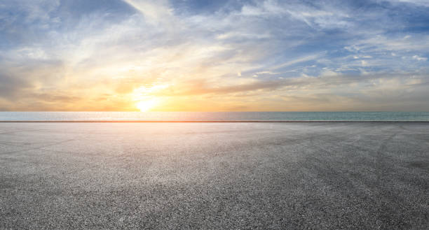 istock Asphalt race track and river with beautiful clouds at sunset 1141564918