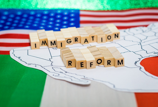 Immigration Reform concept on US-Mexico border map with United States and Mexico flags