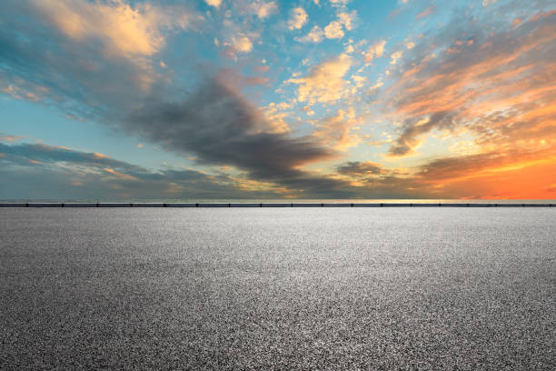 istock Asphalt road and sea with beautiful clouds at sunset 1141565626