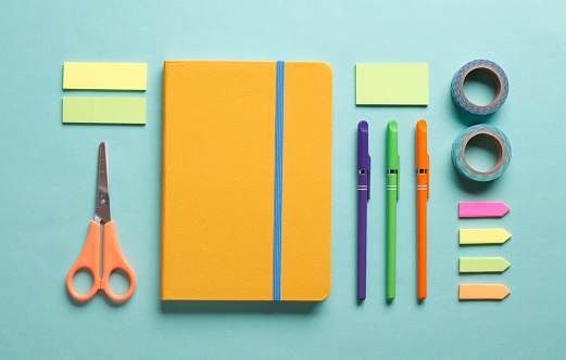 Office desk working space flat lay with colorful supplies