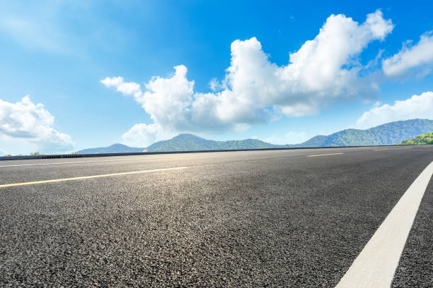 istock Asphalt road and mountains with blue sky on a sunny day 1141566341