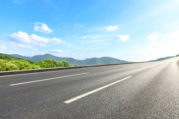 istock Asphalt road and mountains with blue sky on a sunny day 1141566382